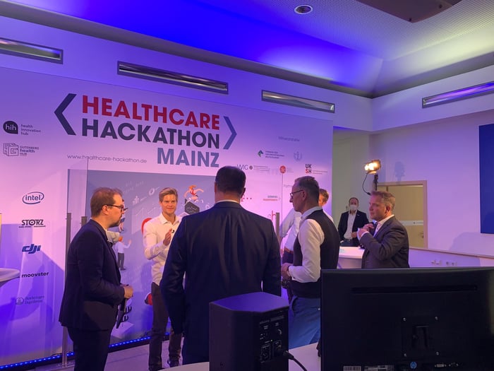 Conference scene at the Healthcare Hackathon Mainz demonstrated a prototype for seamless, secure data integration between hospital IT and the BuddyCare app