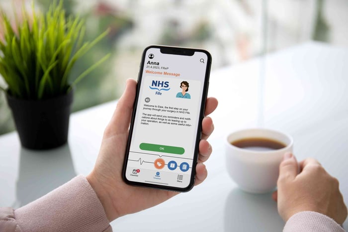 Orthopaedic patient using the NHS Fife ELSIE pre-operative assessment app by Buddy Healthcare to complete digital health questionnaires and receive surgery preparation guidance at home.