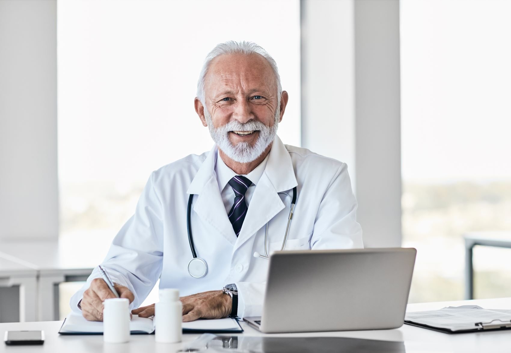 Older doctor is satisfied to the care coordination platform and reports